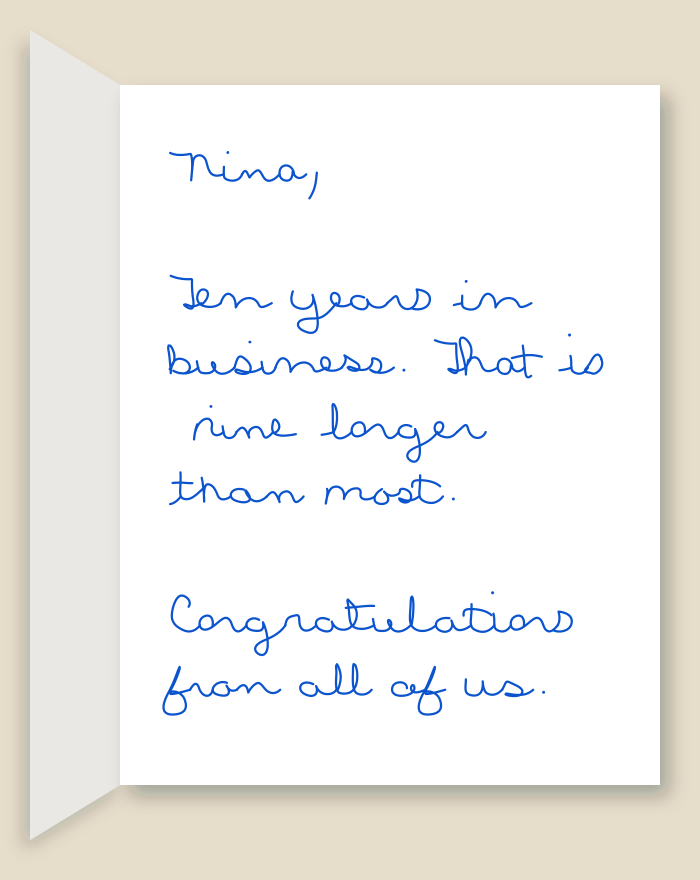 The inside of a handwritten card reading: Nina, Ten years in business. That is nine longer than most. Congratulations from all of us.