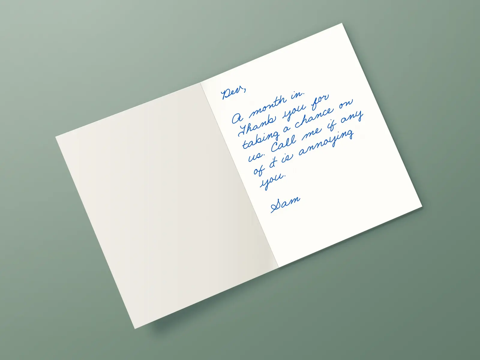 The inside of a handwritten card reading: Dev, A month in. Thank you for taking a chance on us. Call me if any of it is annoying you. Sam