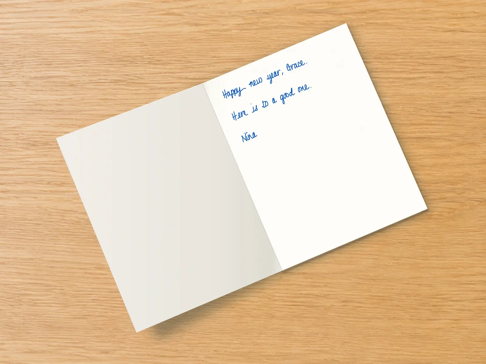 The inside of a handwritten card reading: Happy new year, Grace. Here is to a good one. Nina