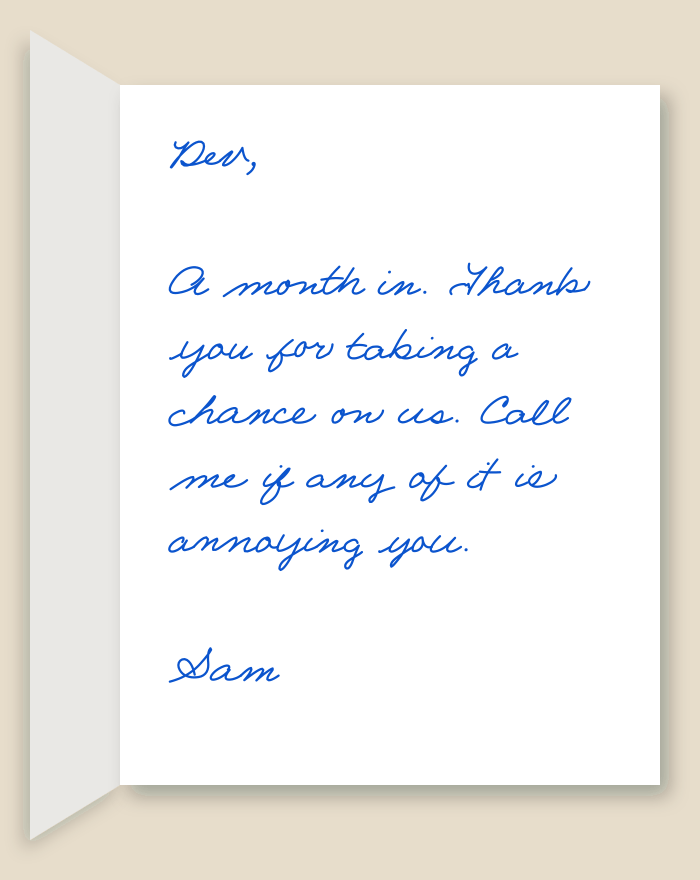 The inside of a handwritten card reading: Dev, A month in. Thank you for taking a chance on us. Call me if any of it is annoying you. Sam