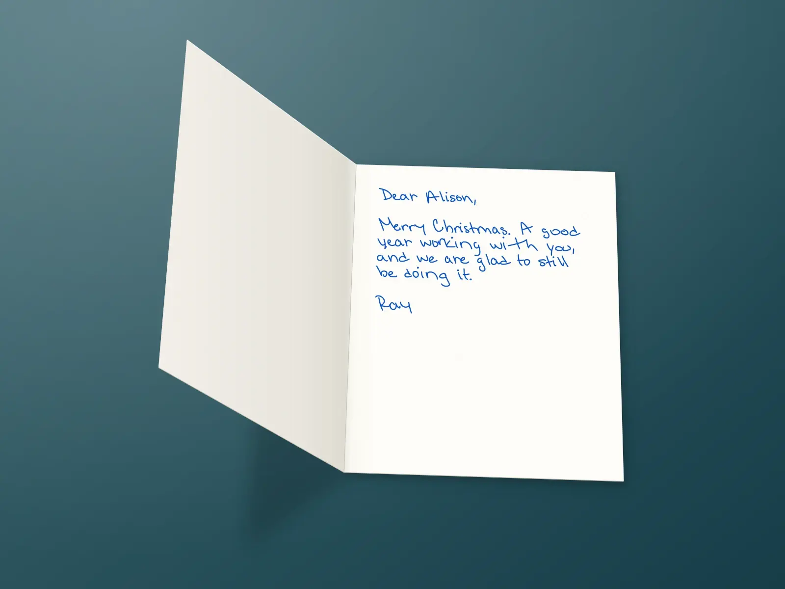The inside of a handwritten card reading: Dear Alison, Merry Christmas. A good year working with you, and we are glad to still be doing it. Ray