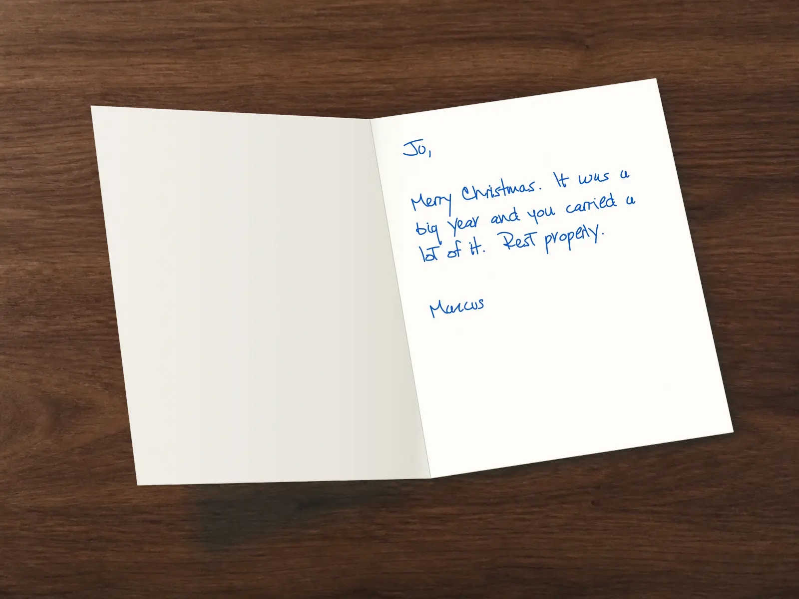 The inside of a handwritten card reading: Jo, Merry Christmas. It was a big year and you carried a lot of it. Rest properly. Marcus