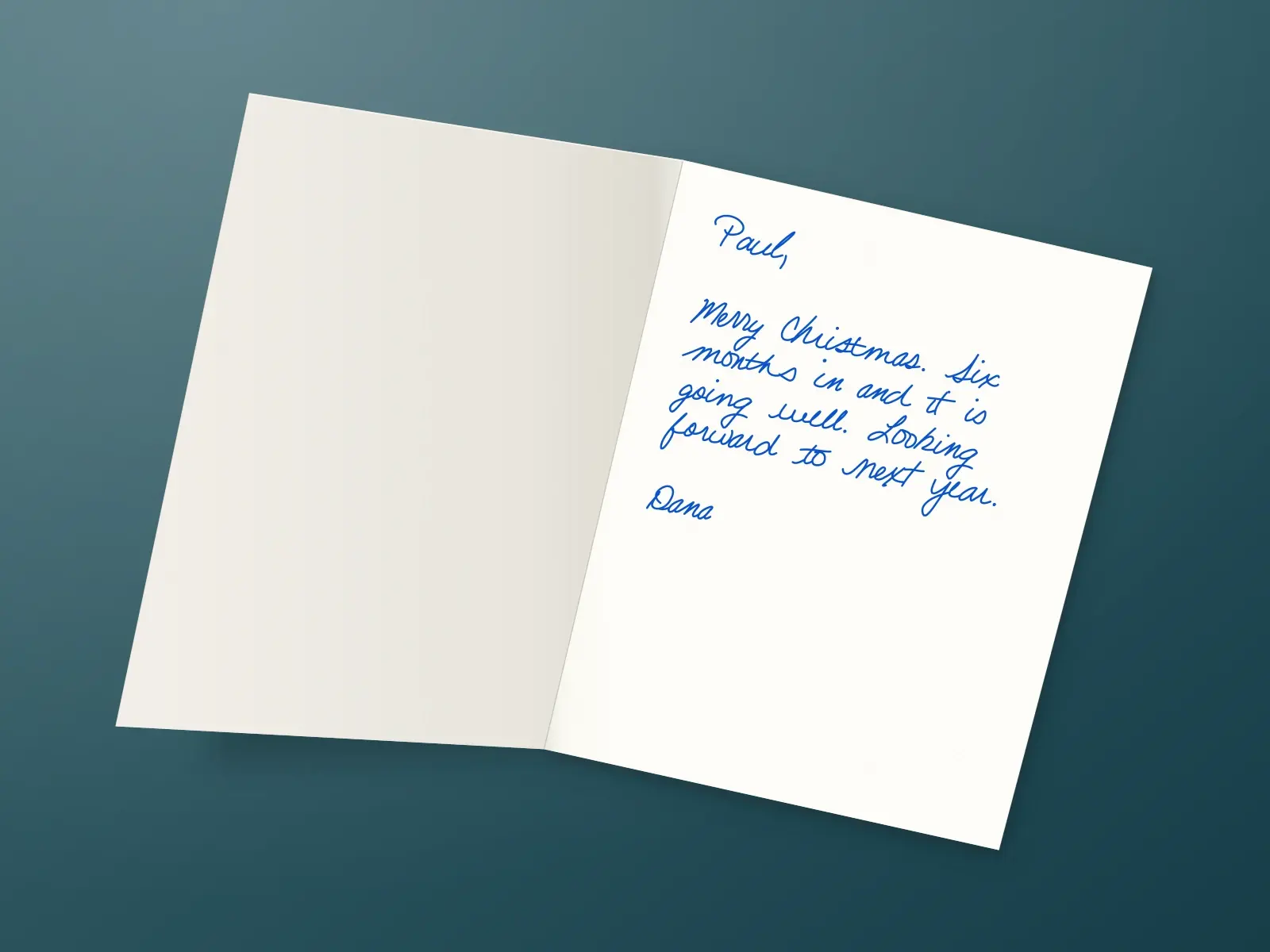 The inside of a handwritten card reading: Paul, Merry Christmas. Six months in and it is going well. Looking forward to next year. Dana