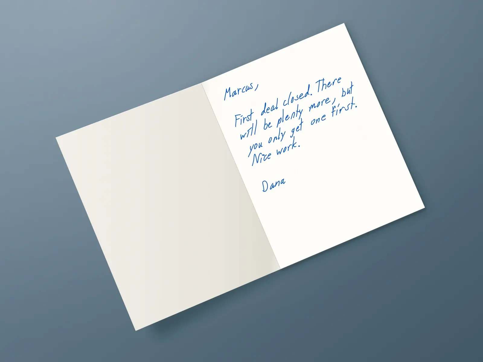 The inside of a handwritten card reading: Marcus, First deal closed. There will be plenty more, but you only get one first. Nice work. Dana