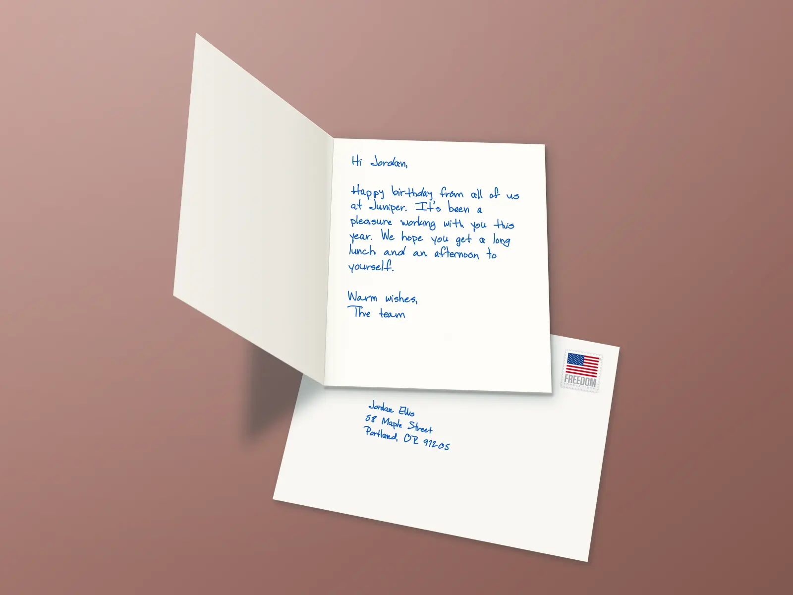A birthday card from the Juniper team to Jordan, wishing them a long lunch and an afternoon to themselves, with a stamped envelope tucked beneath it.