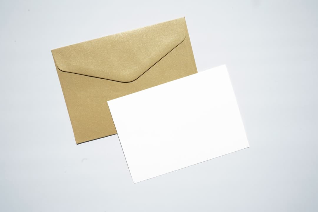 Handwritten letter inside an envelope sitting on a business desk